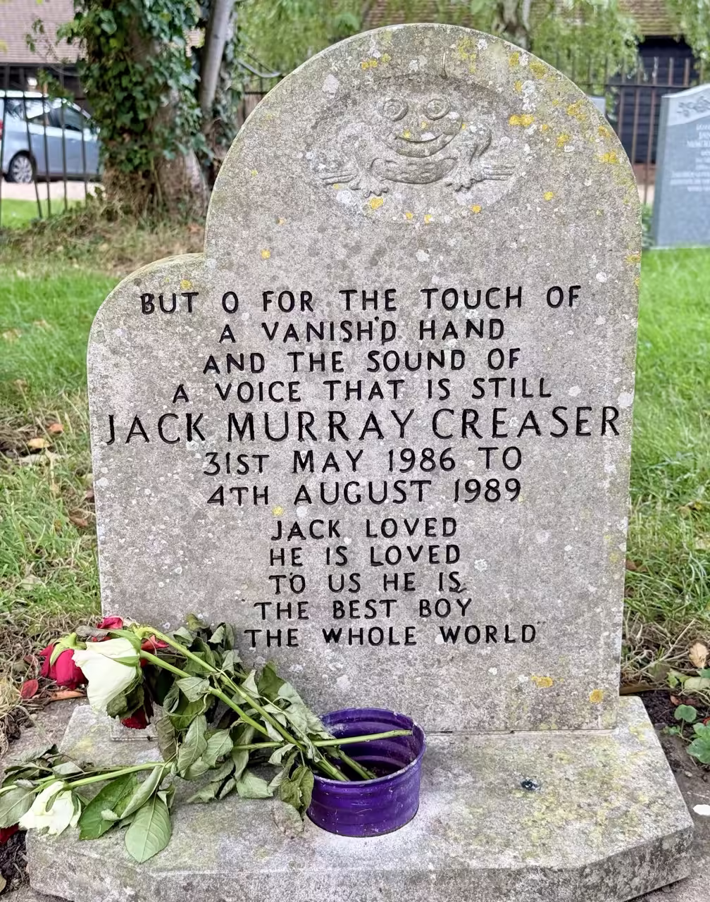 Headstone with carved frog
